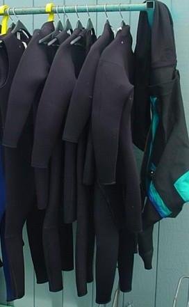 wetsuits hanging to dry